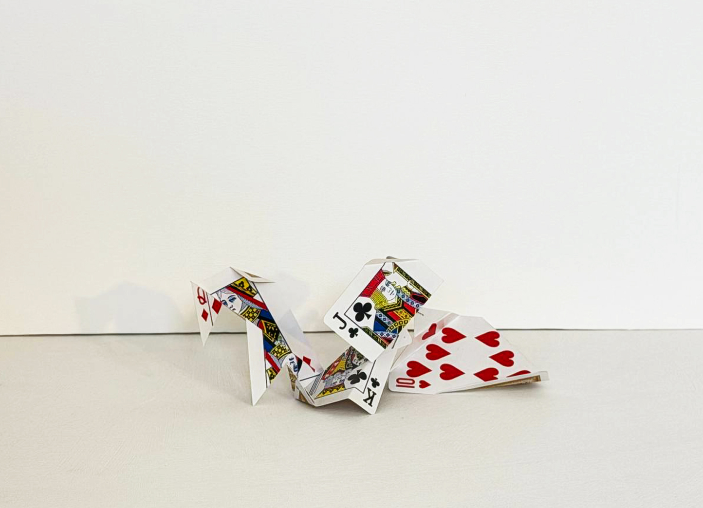 Cut Playing Cards, folded court cards with a fan of hearts extending to one side