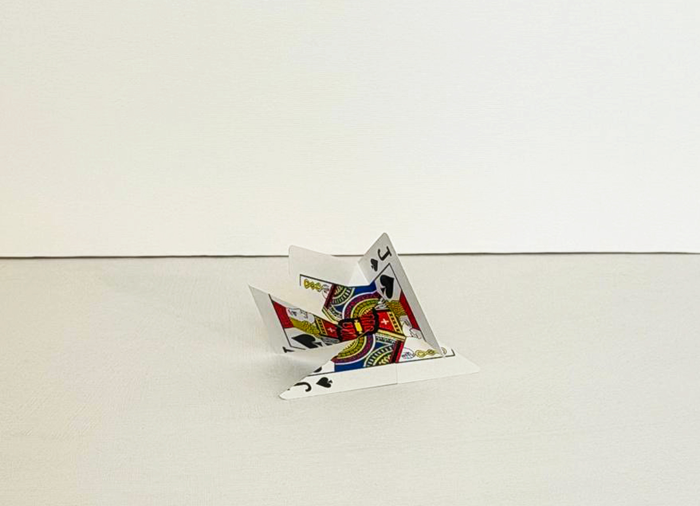 Cut Playing Cards, a low folded structure of playing cards showing clubs and diamonds